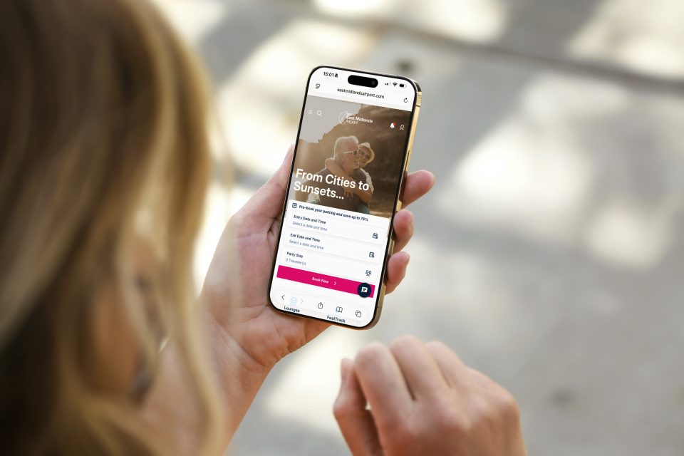 Woman viewing East Midlands Airport website on a phone
